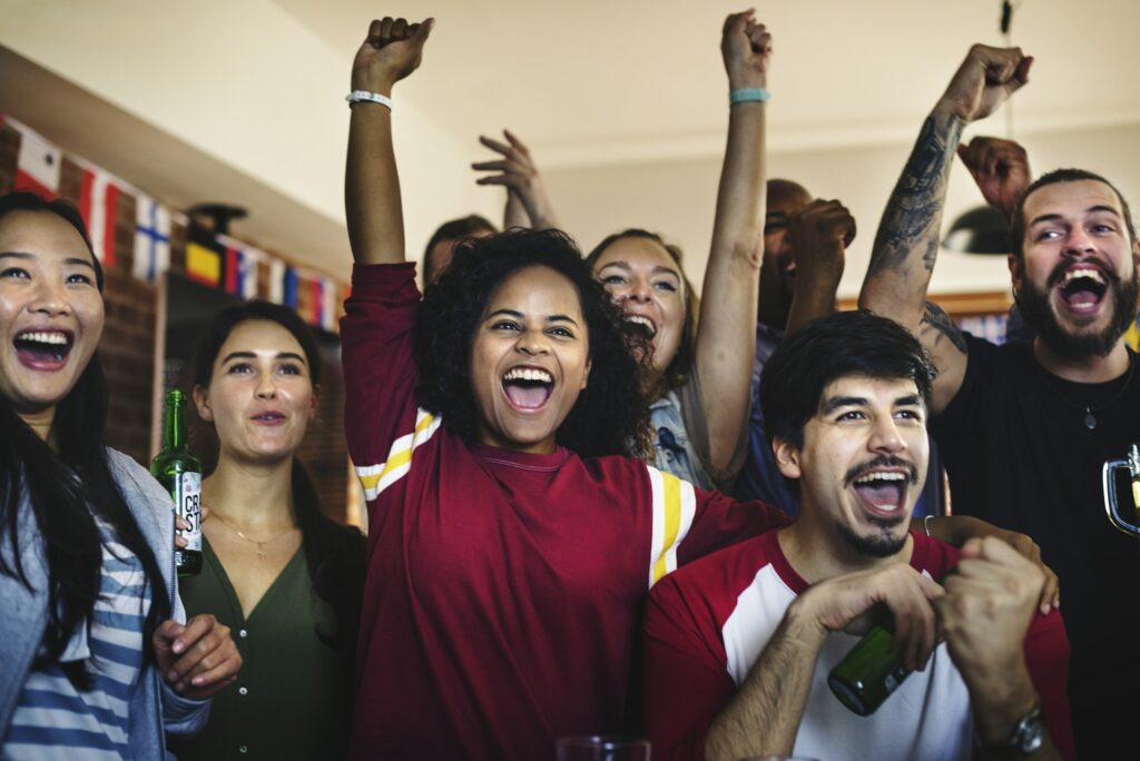 Frieds cheering sport at bar together