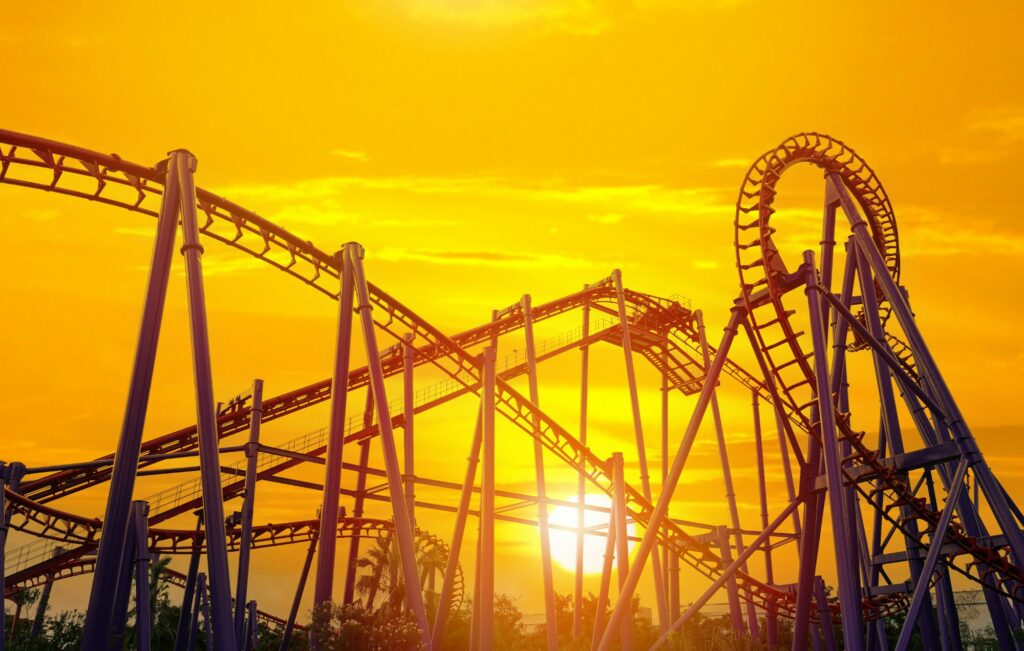 Roller coaster in the amusement park with the sunset background.