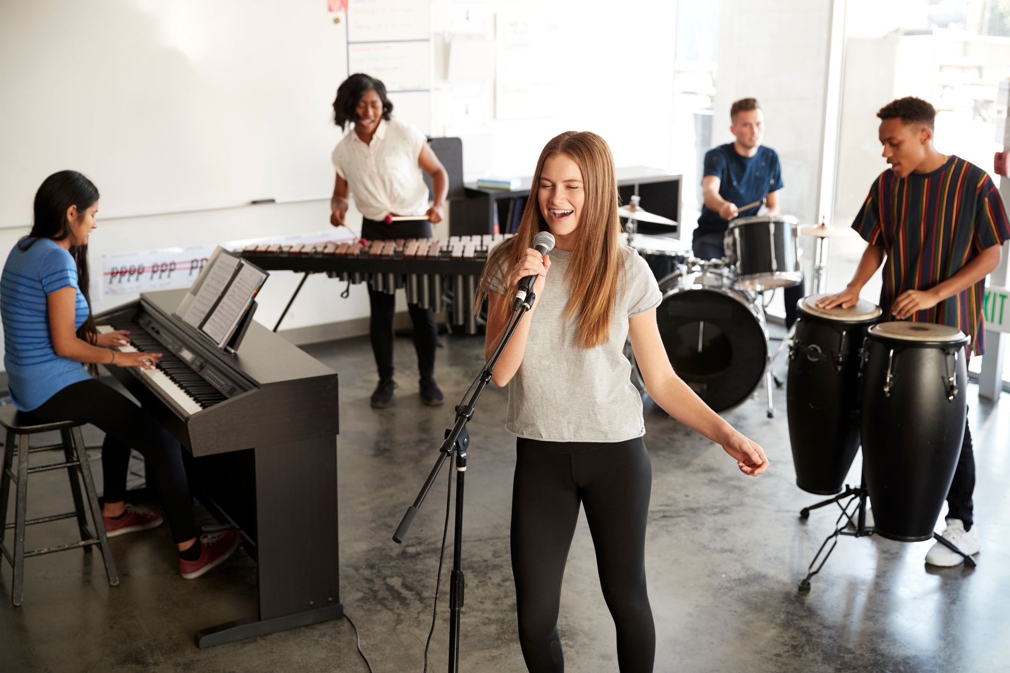Students At Performing Arts School Playing In Band At Rehearsal