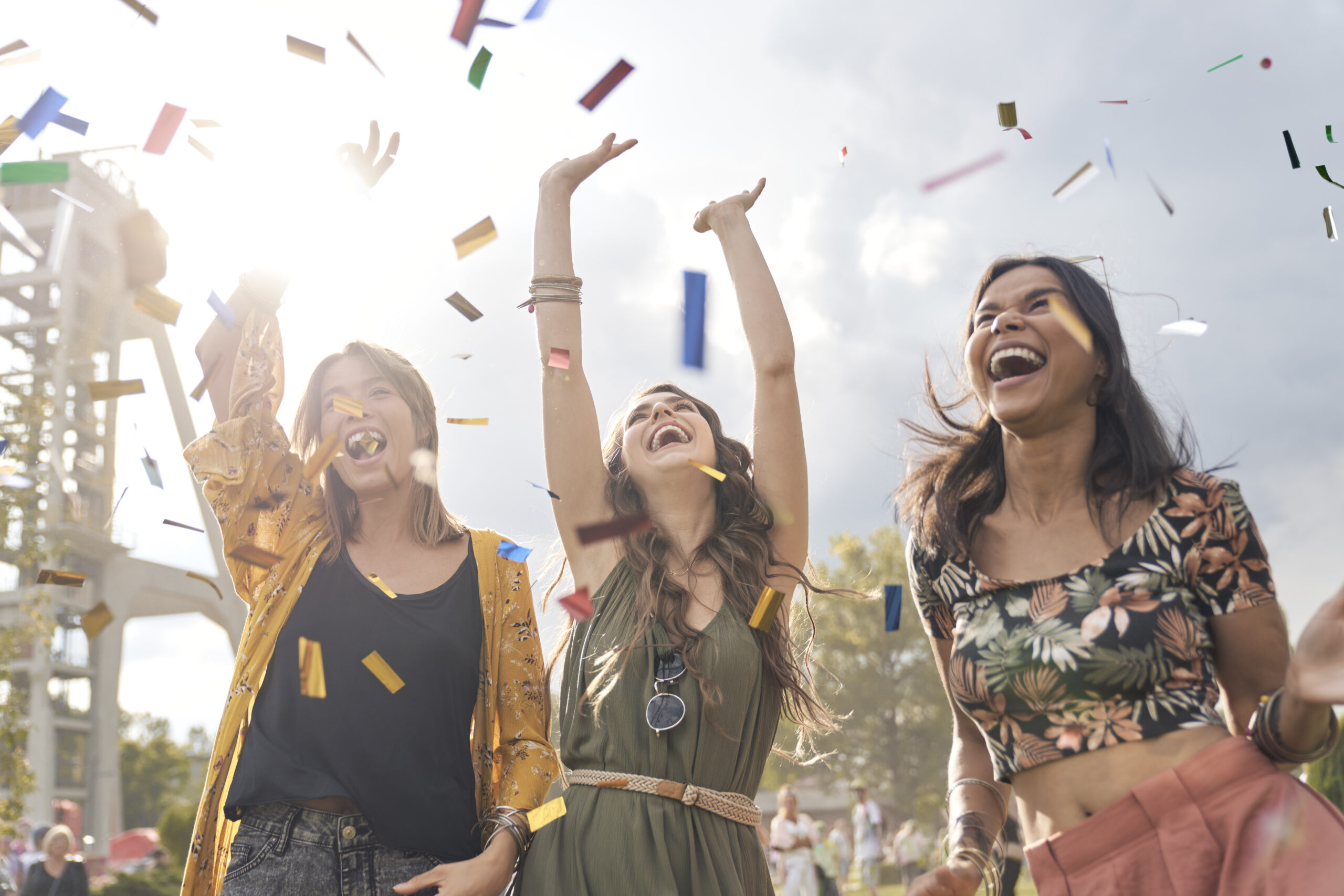 Three friends dancing at the music festival in summer