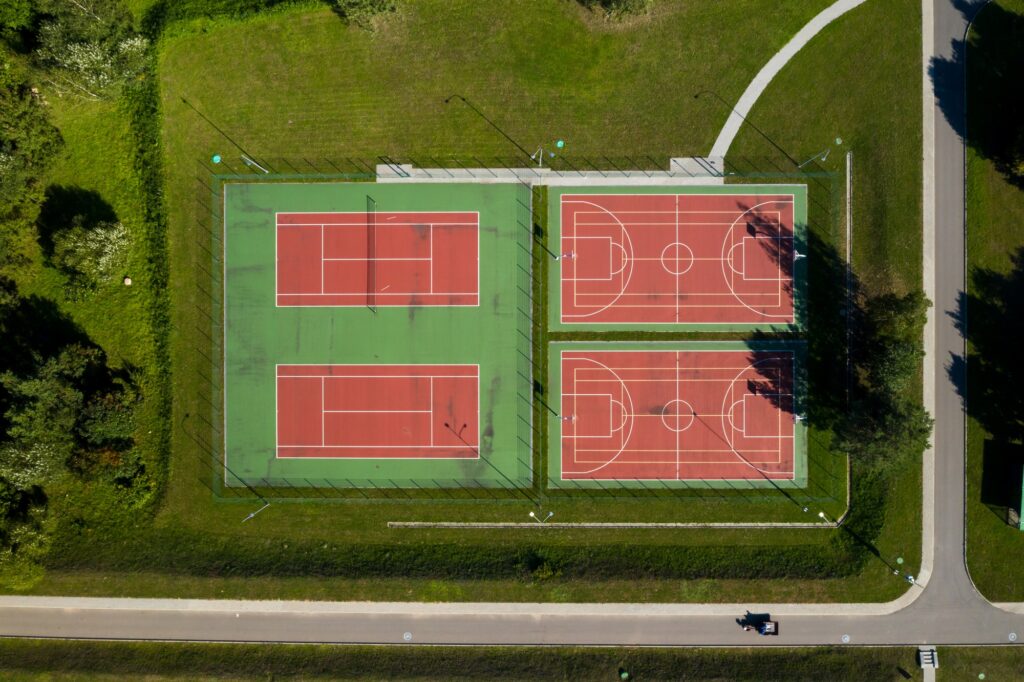 View from the height of the empty Tennis courts in the daytime in summer