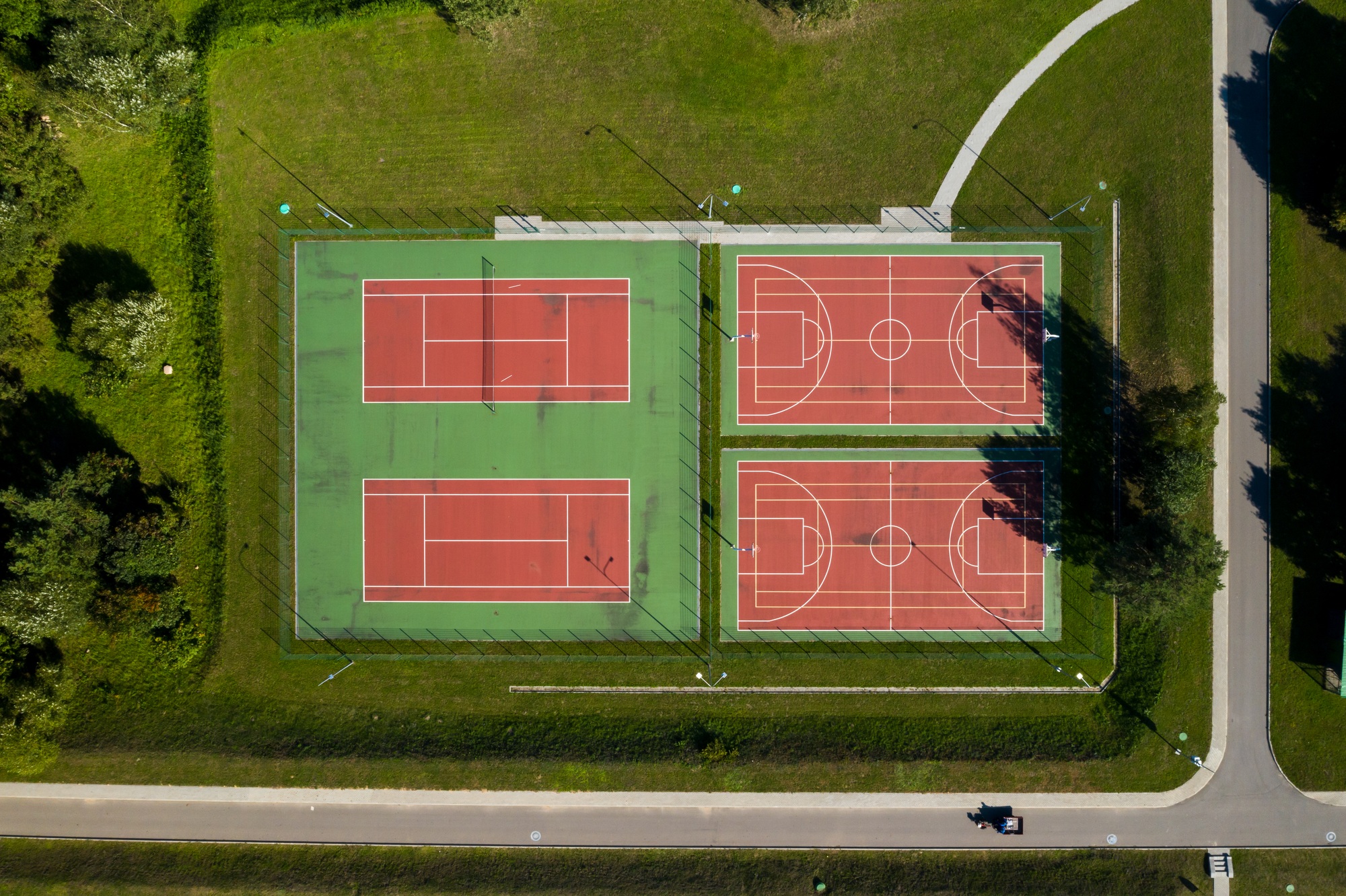 View from the height of the empty Tennis courts in the daytime in summer